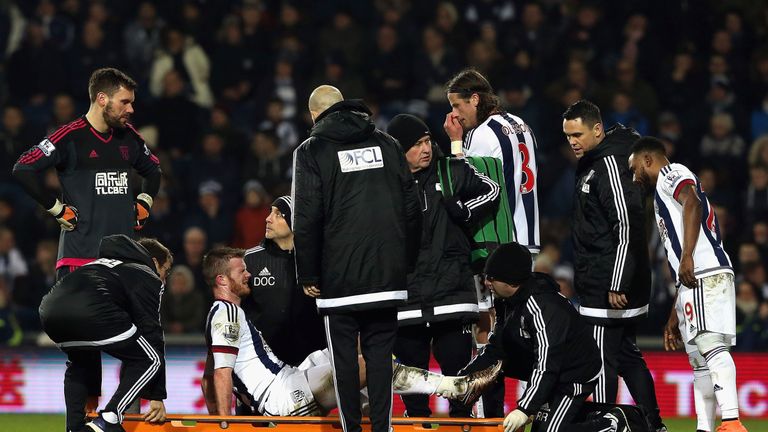 West Brom's Chris Brunt is taken to a stretcher in the first half
