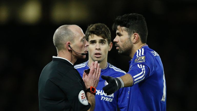 Mike Dean (left) talks with Costa (right) and Oscar in the first half