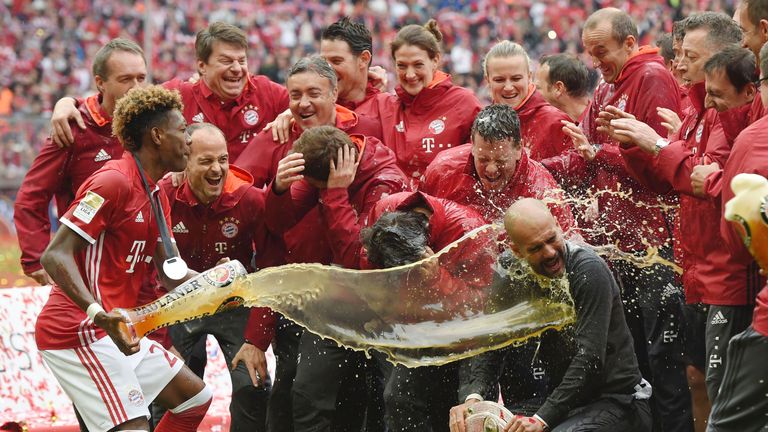 Pep Guardiola is doused in beer following Bayern's title triumph