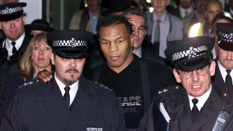 Police guide Mike Tyson through Heathrow after Home Secretary Jack Straw allowed him to enter England