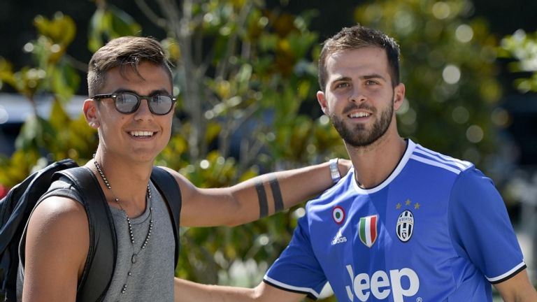 Miralem Pjanic (right) is greeted by new Juventus team-mate Paulo Dybala