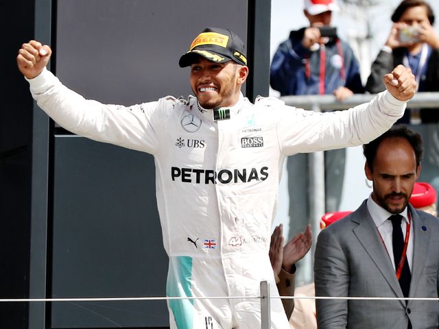 Hamilton celebrates on the podium