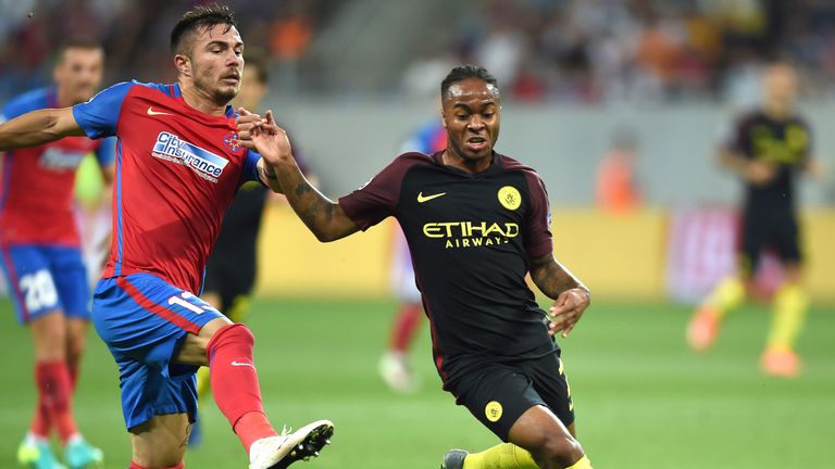 Raheem Sterling (R) vies for the ball with Alin Tosca