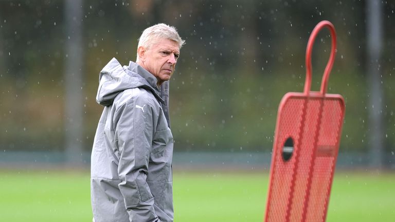 Wenger looks on during a training session at London Colney