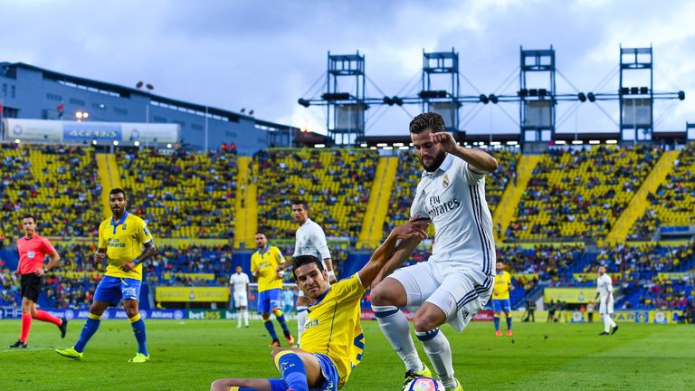 Nacho Fernandez of Real Madrid CF competes for the ball with Vicente Gomez of UD Las Palmas during the La Liga match