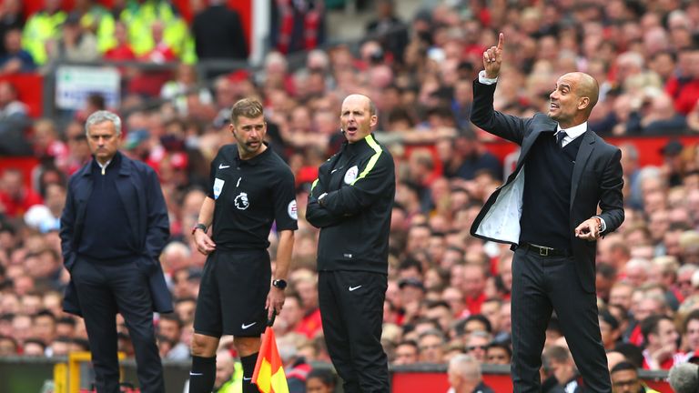 Pep Guardiola (right) reacts on the touchline at Old trafford