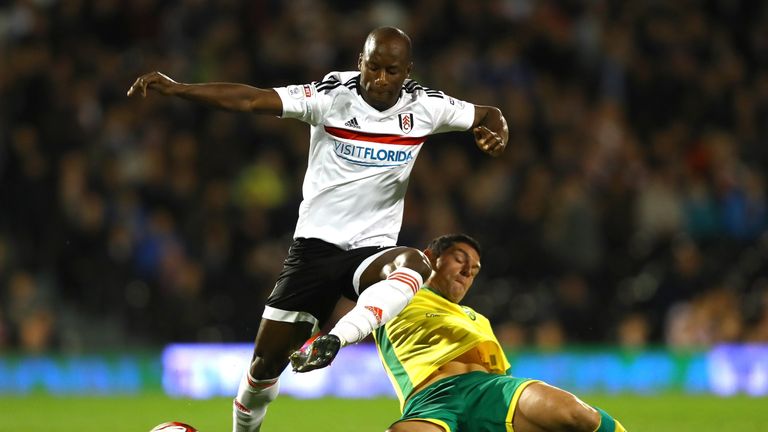 Fulham's Sone Aluko is challenged by Graham Dorrans of Norwich