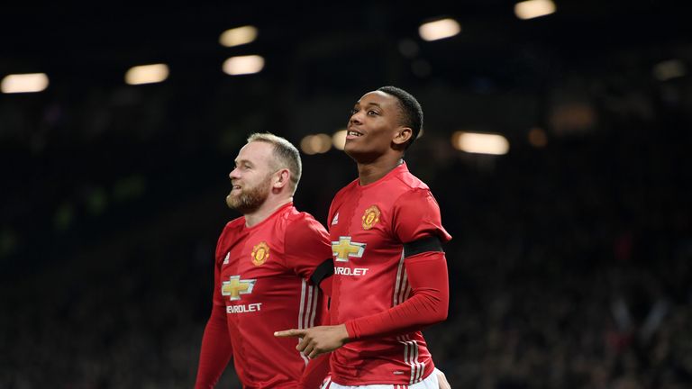 Martial celebrates with team-mate Wayne Rooney