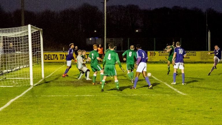 Centre-back Allen Weston (R) strikes against Holker OB - Image courtesy of www.johnmiddletonphoto.co.uk