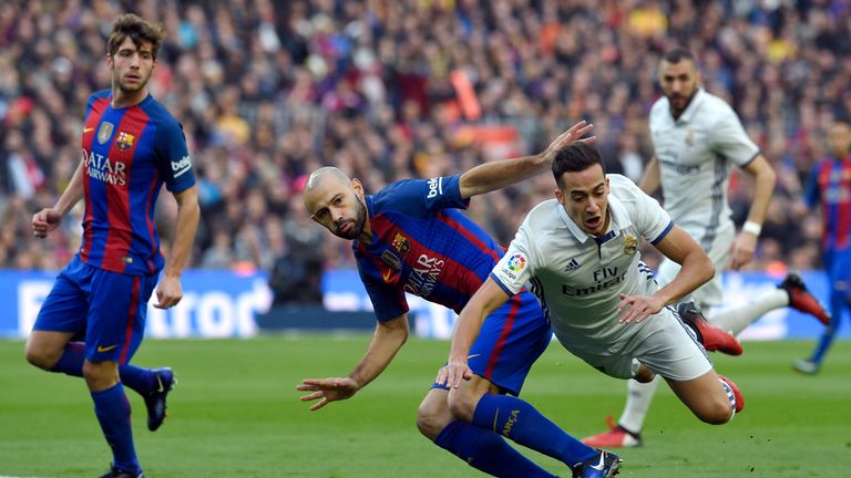 Lucas Vazquez vies with Javier Mascherano at the Nou Camp