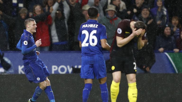 Jamie Vardy celebrates as John Stones reacts in the foreground 