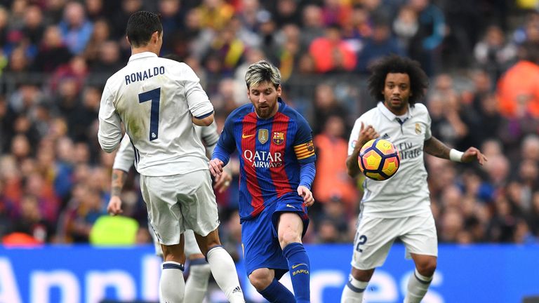 Lionel Messi faces Cristiano Ronaldo and Marcelo during the La Liga match