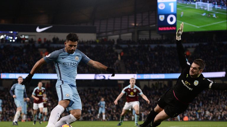 Sergio Aguero (L) scores past Burnley's Tom Heaton