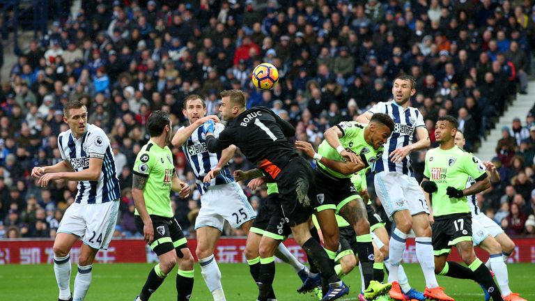 Artur Boruc (right) attempts to punch the ball but misses which leads to West Brom's second
