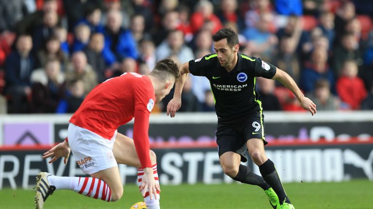 Barnsley's Angus MacDonald (left) and Brighton's Sam Baldock battle for the ball
