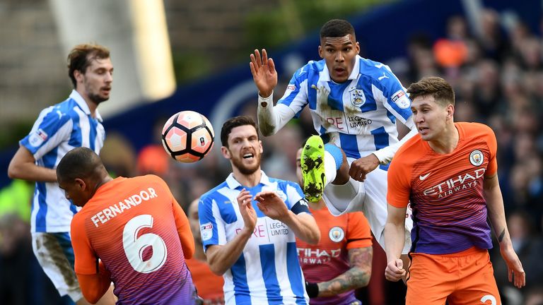 John Stones heads clear under pressure