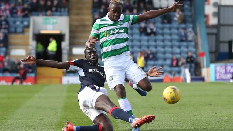 Dundee defender Kevin Gomis tackles Celtic striker Moussa Dembele