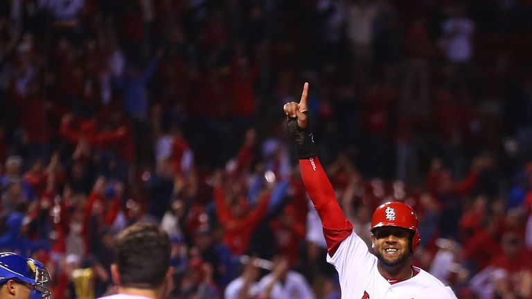 Jose Martinez celebrates scoring the winning run for the Cardinals in the ninth