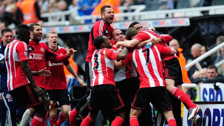 Sunderland manager Paolo Di Canio (centre) celebrates with the team after their 3-0 win at Newcastle
