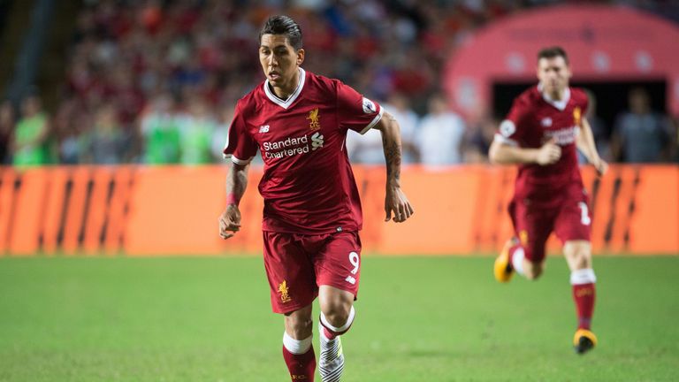 Roberto Firmino drives through the middle of the pitch during the match