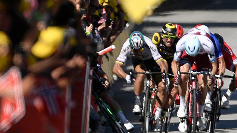 Peter Sagan (second left) causes a crash that sends Mark Cavendish (far left, obscured) into the barriers