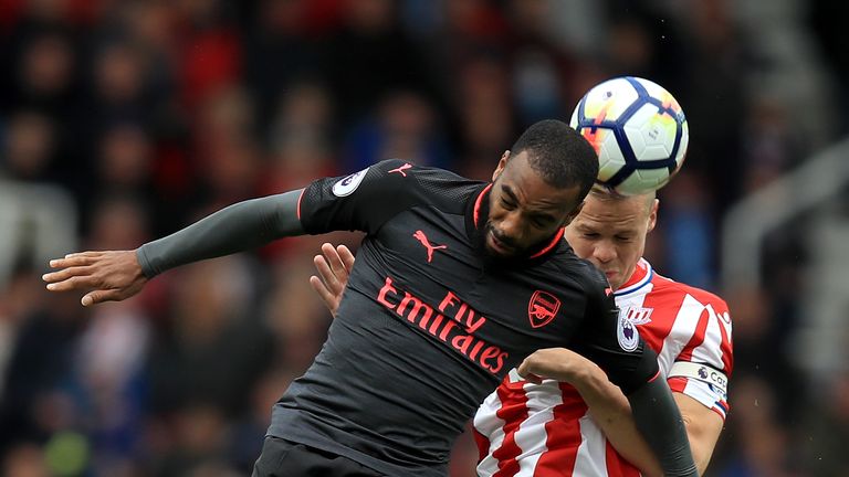 Alexandre Lacazette (L) and Ryan Shawcross battle for the ball