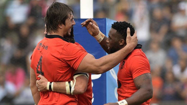 South Africa's flanker Siya Kolisi (R) celebrates with lock Eben Etzebeth (L) and lock Franco Mostert after scoring his team's third try
