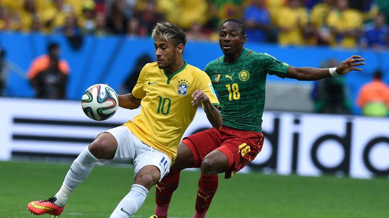 Brazil's forward Neymar and Cameroon's midfielder Eyong Enoh vie for the ball