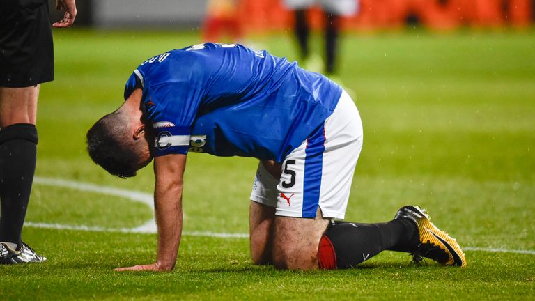 Lee Wallace goes down with an injury in the first half at Firhill