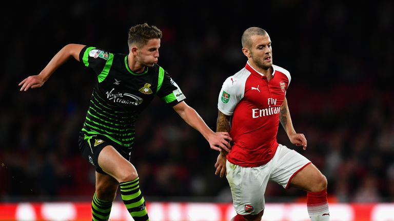 Jack Wilshere attempts to get away from Jordan Houghton of Doncaster Rovers