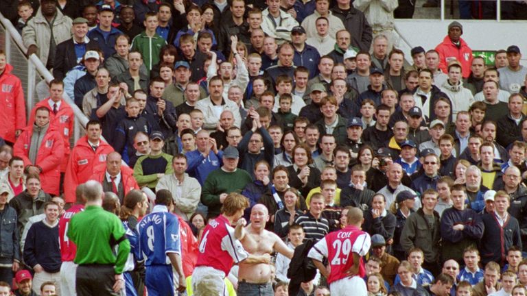 Pitch invader attempts to swap shirts with Alex Nyarko of Everton