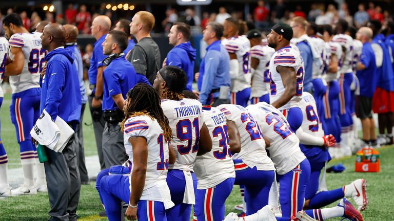 Buffalo Bills players kneel during the national anthem prior to their game against the Atlanta Falcons