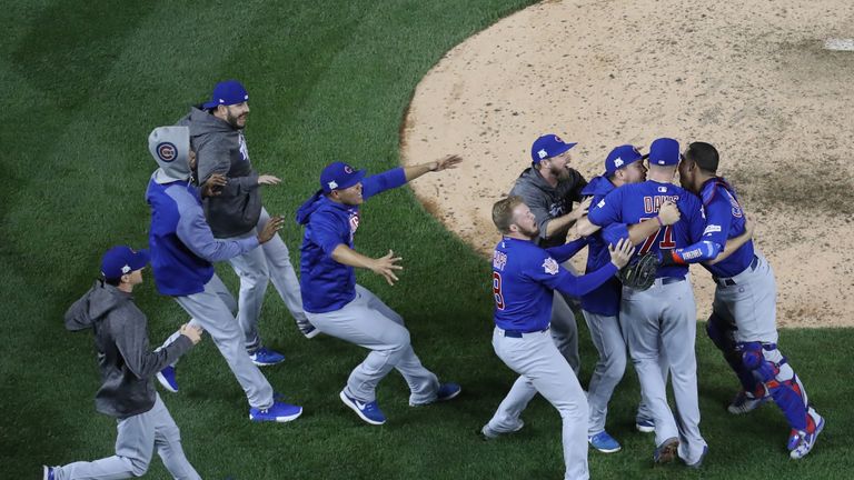 The Chicago Cubs celebrate after a thrilling 9-8 victory
