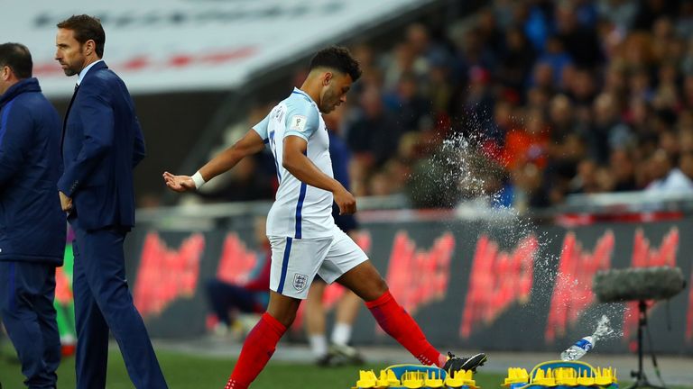  Alex Oxlade-Chamberlain reacts by kicking a bottle as he is substituted