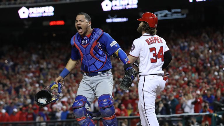 Willson Contreras celebrates after Bryce Harper struck out to end the game