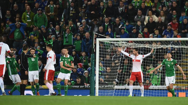 Corry Evans of Northern Ireland concedes a controversial penalty after a handball following a shot from Xherdan Shaqiri.