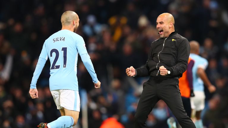 Pep Guardiola and David Silva (left) after City's last-gasp victory against Southampton