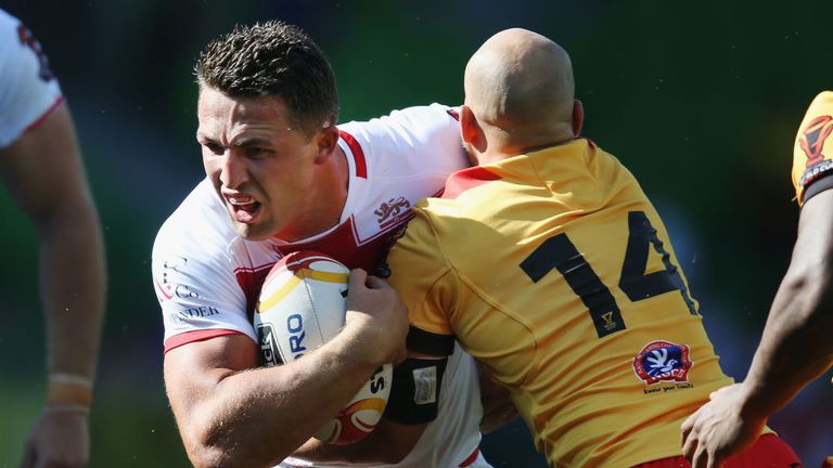 Sam Burgess of England is tackled by Kurt Baptiste of Papua New Guinea