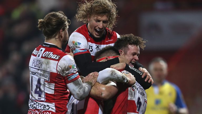 Jake Polledri is mobbed by his Gloucester team-mates after scoring a try against London Irish