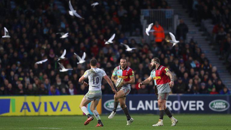 Harlequins' Jamie Roberts runs at Owen Farrell at the Stoop