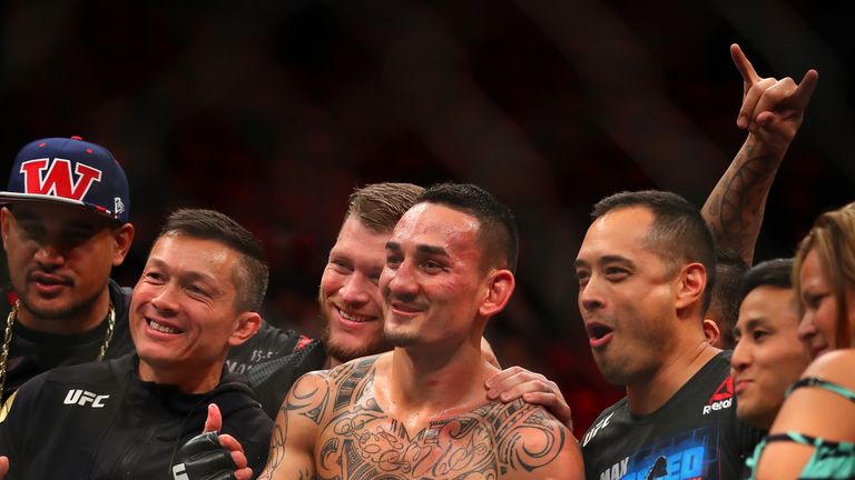 Holloway celebrates victory with his team and family