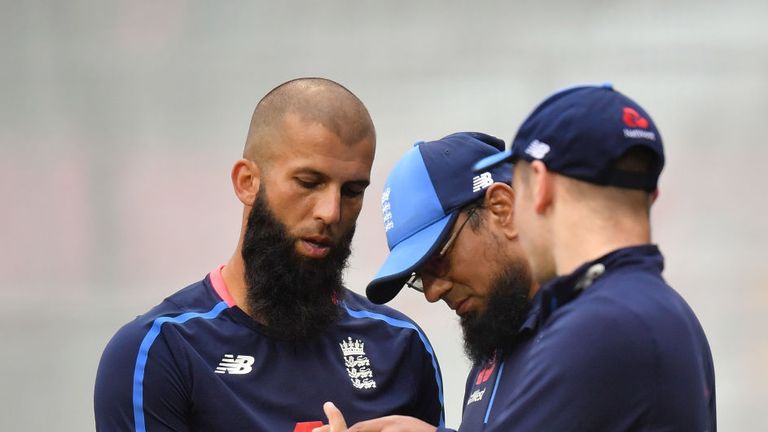 Ali has his finger inspected by bowling coach Saqlain Mushtaq as Mason Crane looks on