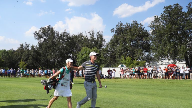 Paisley celebrates with his wife and caddie Keri walking down the 18th green