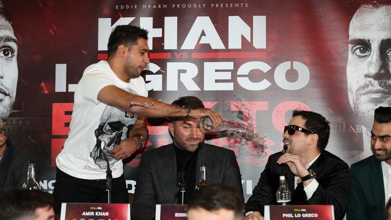 Khan throws a glass of water over Phil Lo Greco at their press conference earlier this year
