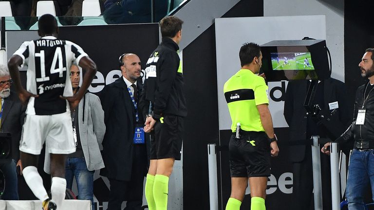 Referee Daniele Doveri (C) undergoes an On-Field Review during Juventus' Serie A match with Fiorentina back in September
