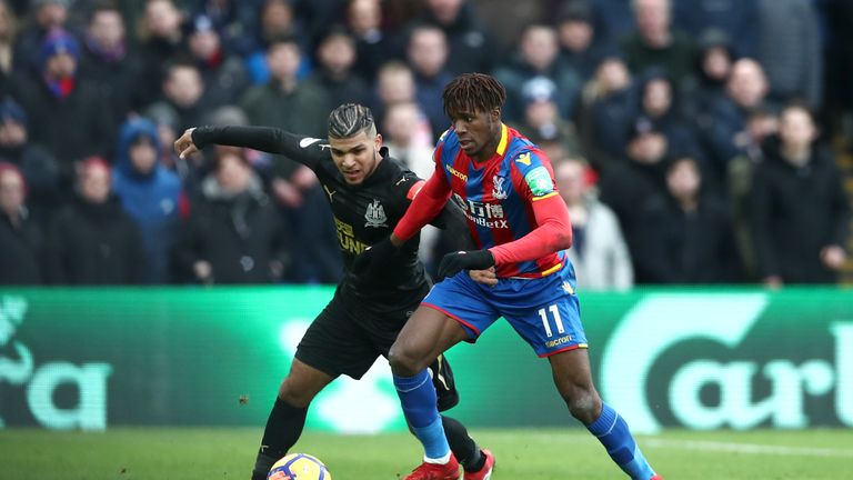 Wilfried Zaha (right) was injured against Newcastle but remained on the pitch