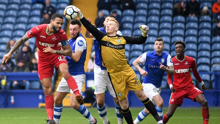 Sheffield Wednesday goalkeeper Cameron Dawson clears the ball from Kyle Bartley's header