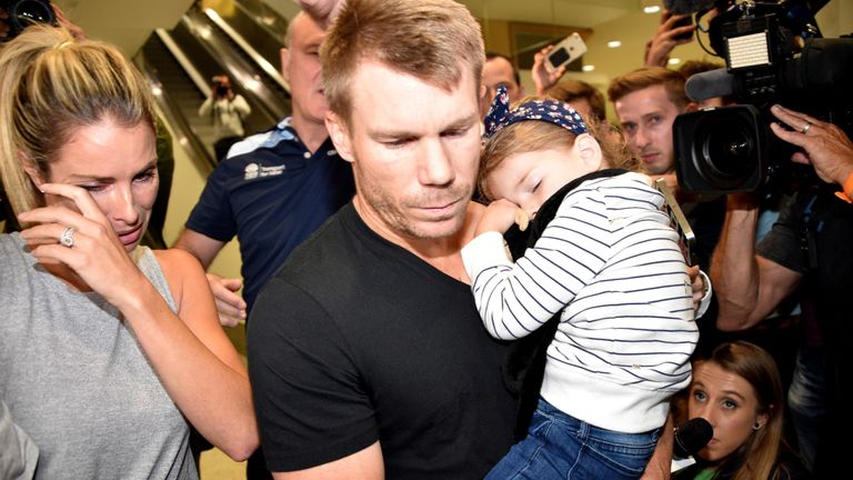 David Warner (C) and his wife Candice after his arrival in Sydney on Thursday