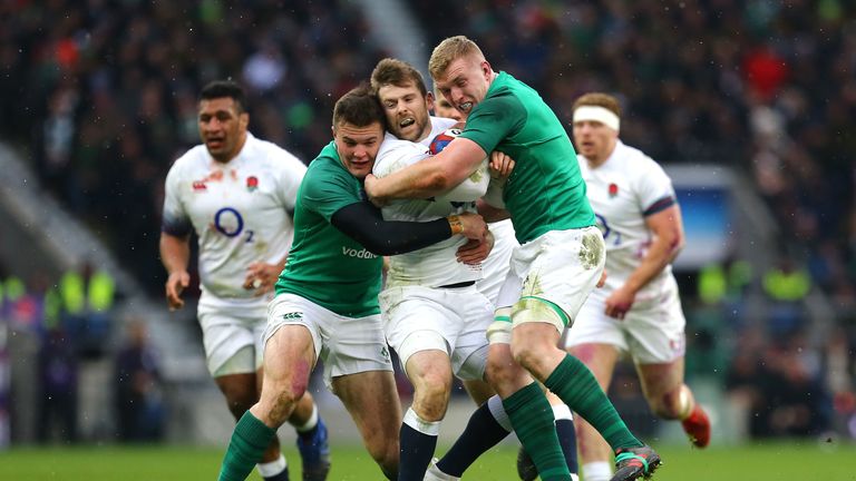England's Elliot Daly (C) is tackled by Ireland's Dan Leavy (R) and Jacob Stockdale (L)