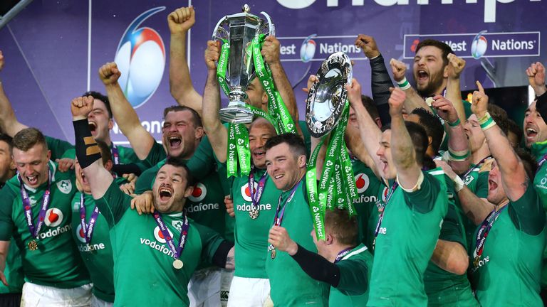Ireland's Peter O'Mahony (C) and teammates celebrate with the trophy after winning the Grand Slam
